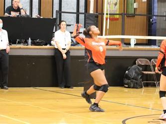 Varsity Volleyball blocking the ball