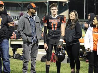 Senior football players with parents