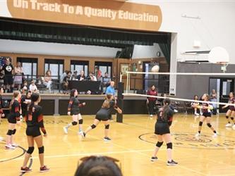 Junior Varsity volleyball defending the court