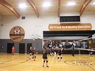 Junior Varsity Volleyball defending the court