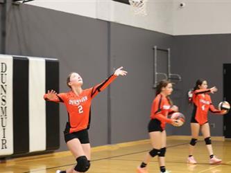 Varsity Volleyball serving the ball