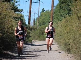 Two cross country girls running together