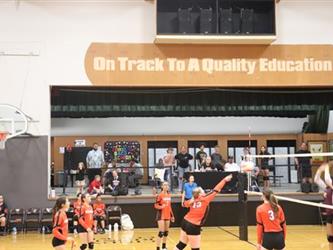 Volleyball players hitting the ball over the net