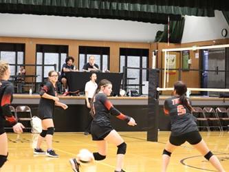 Volleyball team mates go for the ball