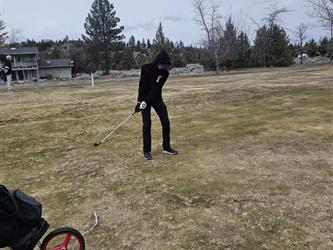 swinging golf club