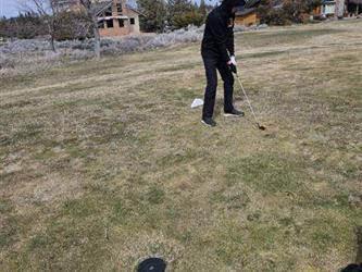 swinging golf club