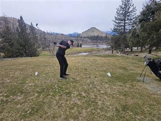 swinging golf club