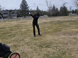 swinging golf club