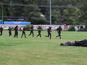 football players running onto field